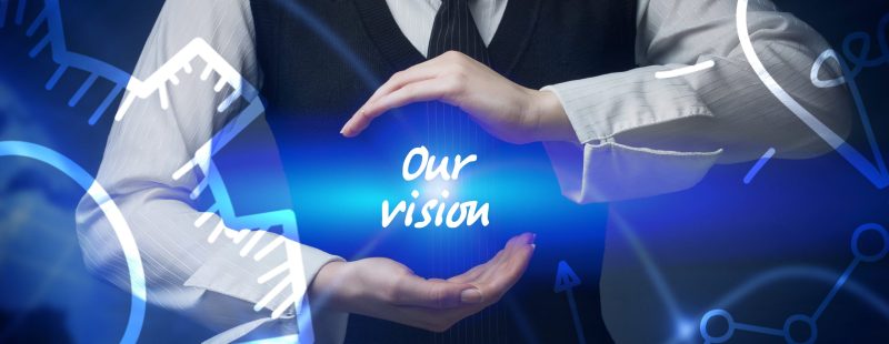 Businessman holding the words "Our Vision" written in light