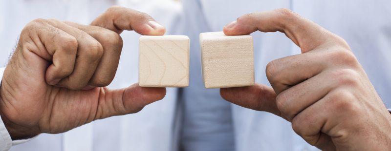 businessmen-holding-cubes-close-up